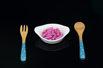 Fototapeta na wymiar pink capsules for meal