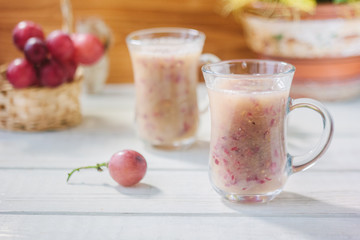 Grape smoothie over the white table.