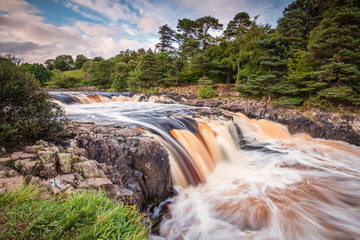 River Tees cascades over Low Force / The River Tees cascades over the Whin Sill at Low Force Waterfall, as the Pennine Way follows the southern riverbank