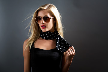 Beautiful young blonde woman in a black dress