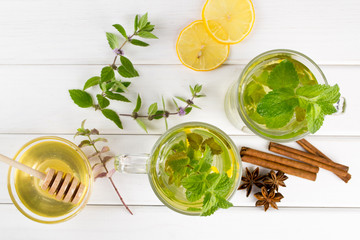 Cup of tea with mint, lemon and honey, cinnamon, anise. Top view 