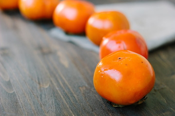 Persimmon snake on wooden surface