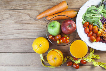 Fresh healthy salad with different fruits and vegetables on wooden background