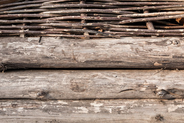 Wooden logs and wattle wall