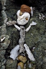 primitive sculpture of a figure made of rock, coral, stone and coconuts on Drunk Bay, St. John, USVI, Virgin Islands, Caribbean
