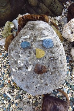 primitive sculpture of a face made of rock, coral, stone and coconuts on Drunk Bay, St. John, USVI, US Virgin Islands, Caribbean