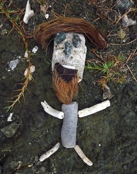 primitive culpture of a figure made of rock, coral, stone and coconuts on Drunk Bay, St. John, USVI, US Virgin Islands, Caribbean
