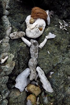primitive sculpture of a figure made of rock, coral, stone and coconuts on Drunk Bay, St. John, USVI, Virgin Islands, Caribbean
