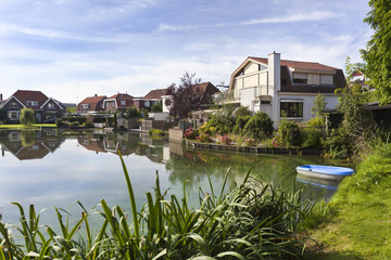 Fototapeta premium Traditional houses around a pond in the Netherlands