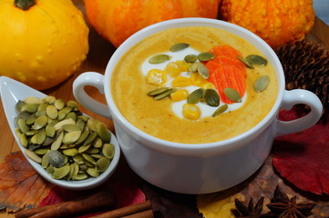 Spicy pumpkin soup in a white bowl, selective focus