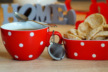 Hot tea in red cup and diet cereal wafers - selective focus
