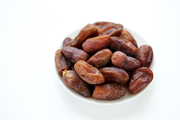 Bowl of dried dates isolated on white backgroun