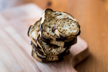 Stack of Fried Eggplant on wooden surface.