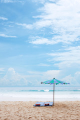 Vacation time at Phuket, Thailand, Mat, and Pillow under the umbrella at the beach. Cloudy background