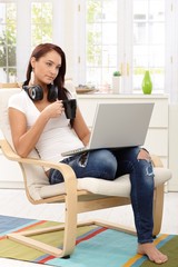 Pretty girl enjoying leisure time with laptop