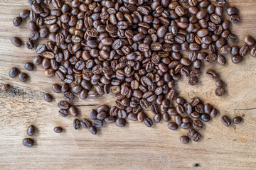 Group of coffee bean on teak wood with nice texture