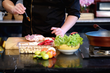 Close Up hands chef cooking raw material in the kitchen