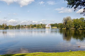 Obraz premium view of the city park and the church from the lake