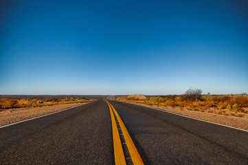 Asphalt with yellow lines at La Pampa dessert in Patagonia, Argentina