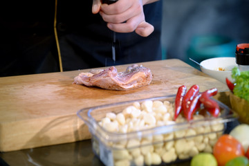Close Up hands chef cooking raw material in the kitchen
