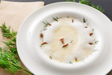 Delicious cream soup with honey fungus close up
