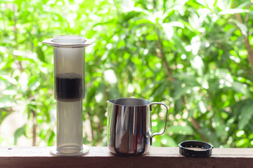 Travel manual coffee machine set, Green bokeh background, Nature