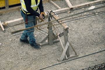Worker hands making reinforcement metal framework