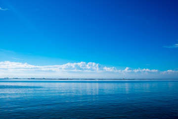 Naklejka na ściany i meble seascape, blue sky and sea with white clouds