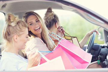 Happy group of friends shopping in autumn season