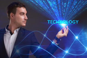 Business, Technology, Internet and network concept. Young businessman working on a virtual screen of the future and sees the inscription: Technology