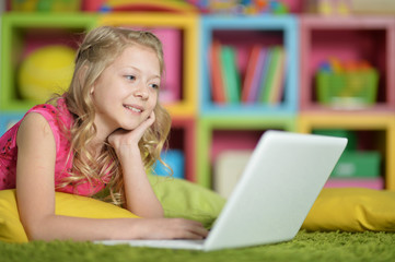 Cute little girl with  laptop 