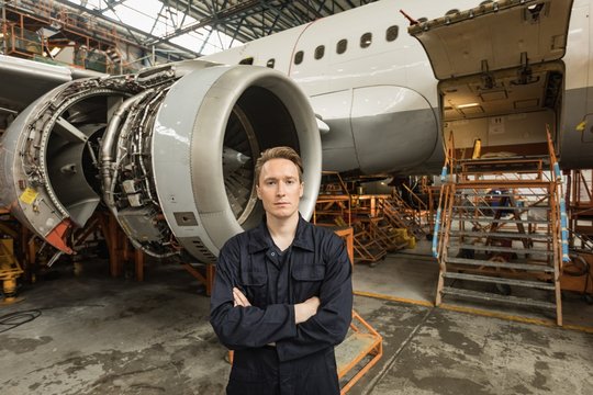Portrait of engineer standing in hangar