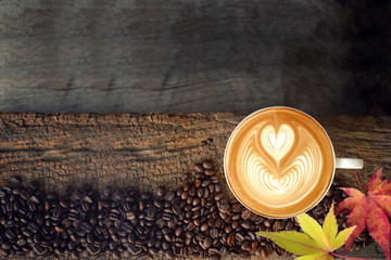Coffee latte art and coffee beans in autumn.
