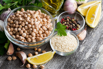 fresh ingredients for preparing hummus on wooden background, top view