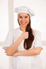 young blonde chef woamn holds kitchenware as she prepares to cook a meal isolated over white background