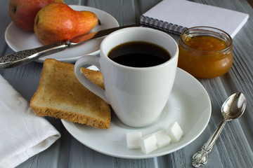 Breakfast with coffee,toast, jam and pear on the  grey wooden  background