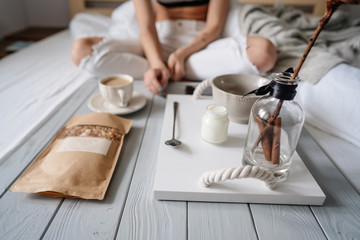Woman eating cereals in bed