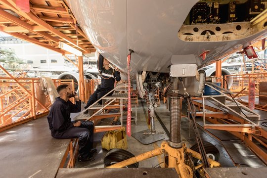 Male aircraft maintenance engineer working over an aircraft