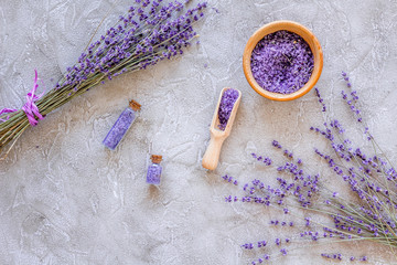 Fototapeta na wymiar bath salt in herbal cosmetic with lavender on stone desk background top view space for text