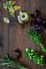 home cooking with fresh greenery and organic oil on wooden table background top view mock up