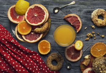 Fototapeta na wymiar Orange, grapefruit and lemon on the table with nuts and honey