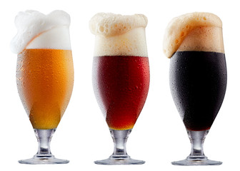 Mug collection of frosty dark red and light beer with foam isolated on a white background