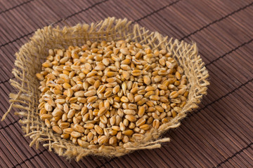 Wheat grains on a brown background