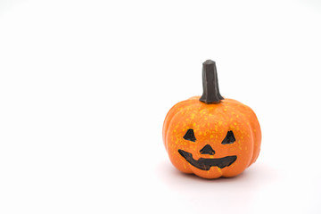 Halloween Concept.  Mini Jack o' lantern pumpkin toys on white background.