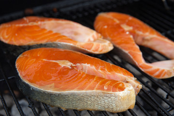 Salmon red fish steaks on the flaming grill