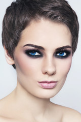 Young beautiful woman with pixie haircut and smokey eyes