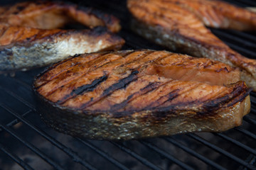 Salmon red fish steaks on the flaming grill