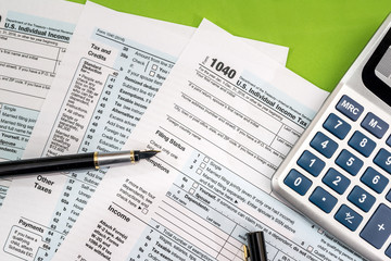 1040 Tax form, pen and calculator