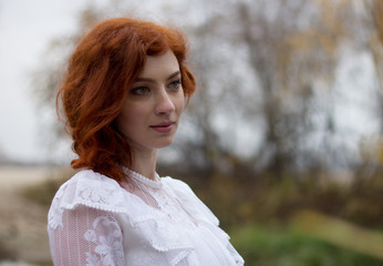 Beautiful young woman with red hair. Portrait.