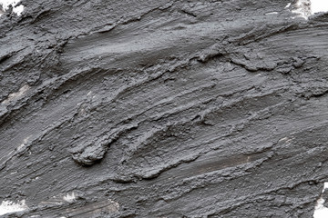 Black volcanic cosmetic clay texture close up. solution of cosmetic clay abstract background